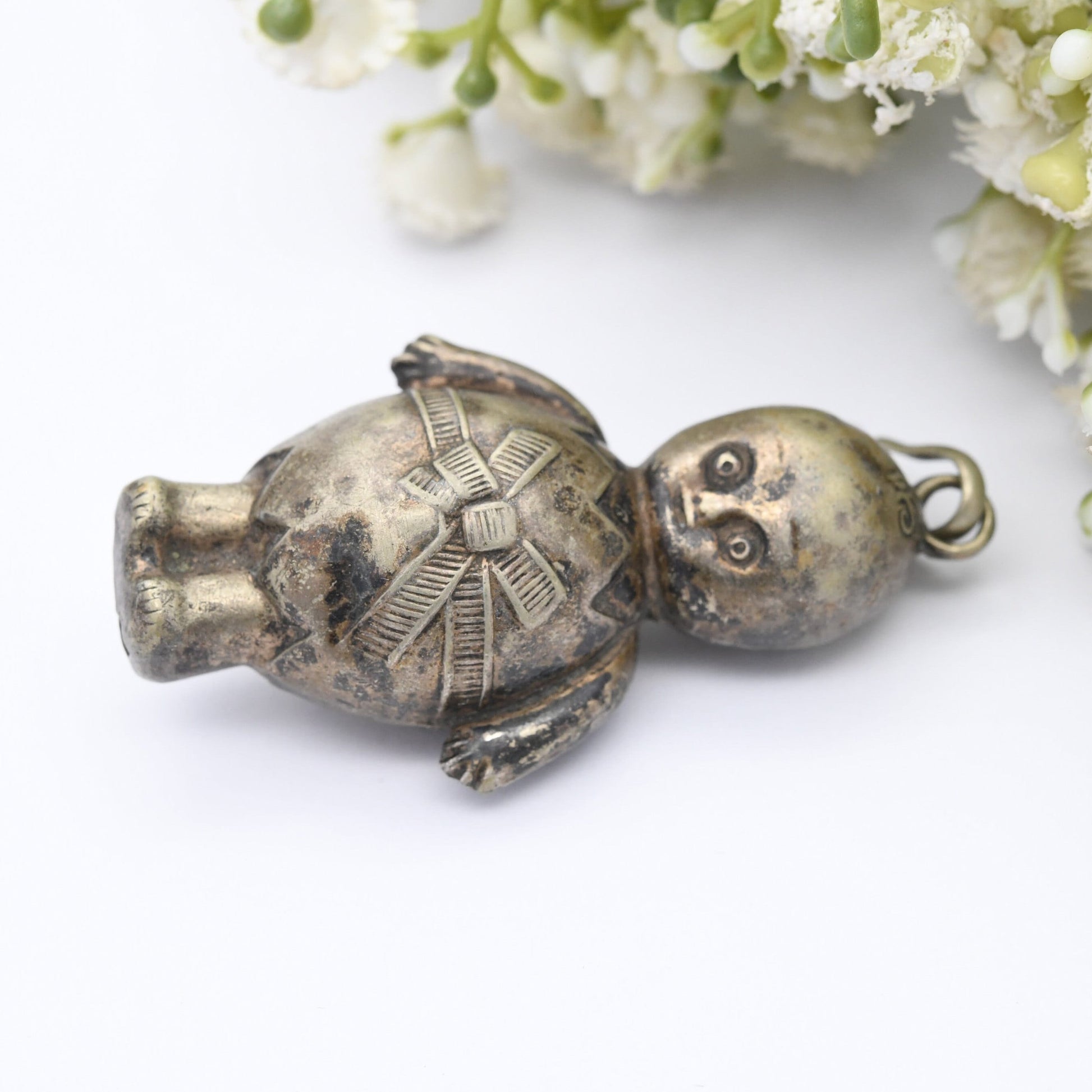 Antique Victorian EPNS Baby Rattle in the Form of a Baby wearing a Cracked Egg and a Bow