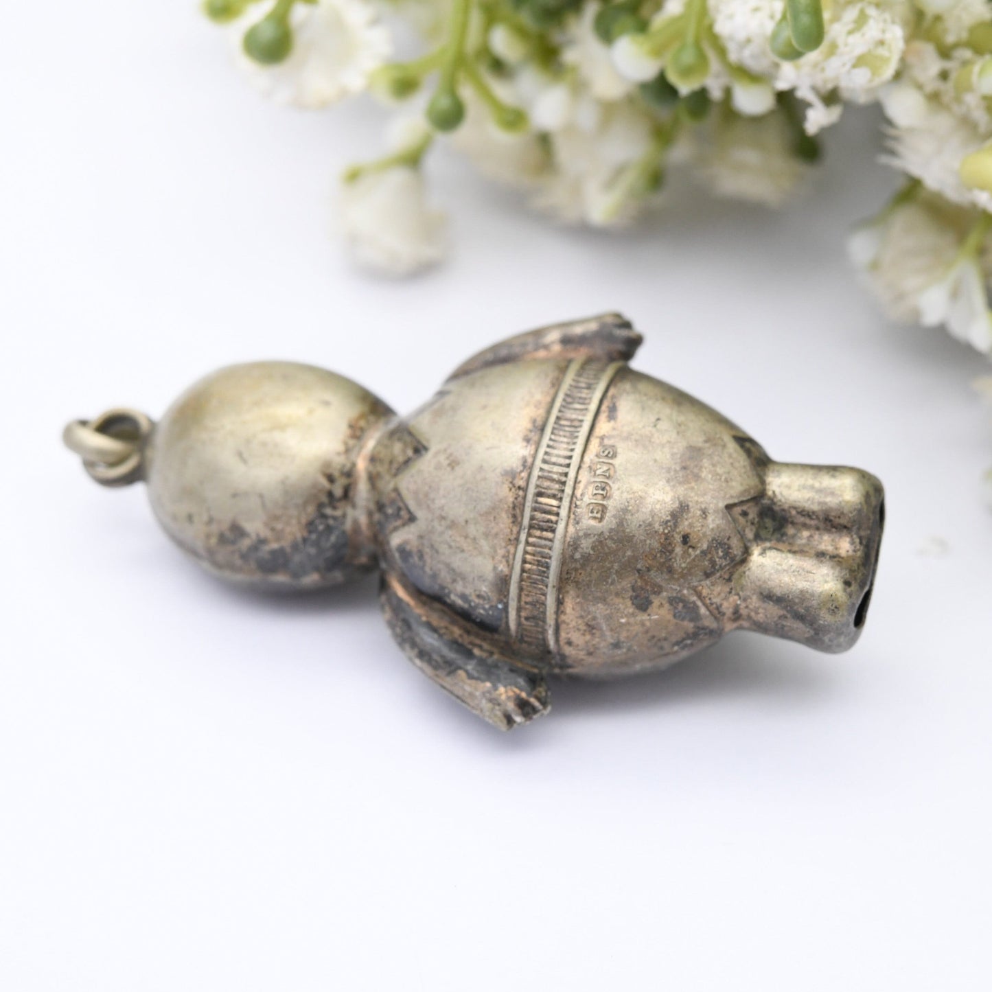 Antique Victorian EPNS Baby Rattle in the Form of a Baby wearing a Cracked Egg and a Bow