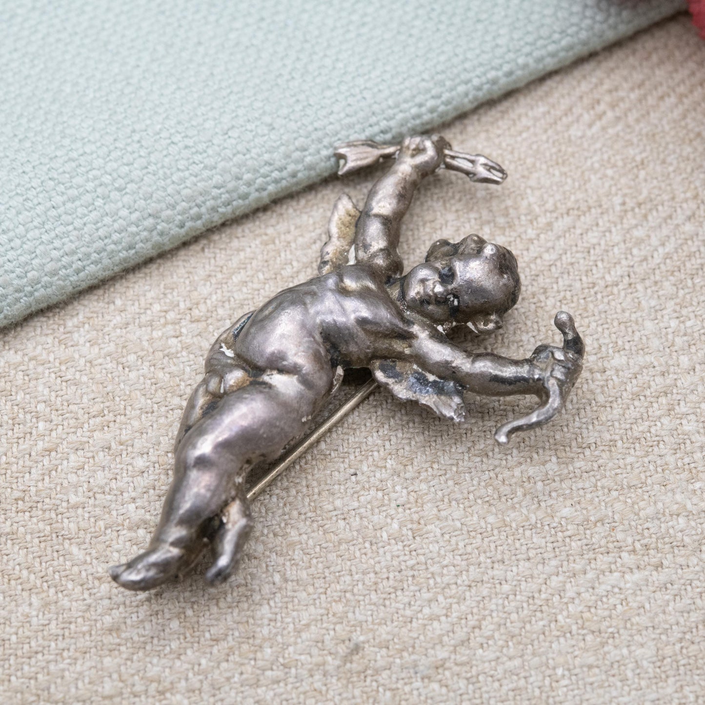 Antique Art Nouveau Repoussé Cherub Brooch c. 1900 - Winged Cupid with Bow and Arrows
