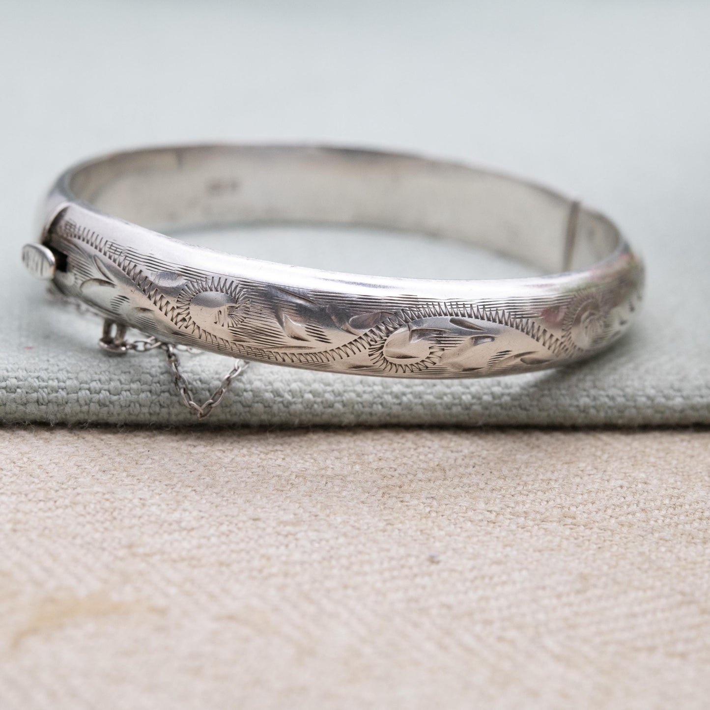 Vintage Sterling Silver Floral Engraved Bangle Bracelet 1972 - Textured Victorian Aesthetic Scrolling Style with Safety Chain