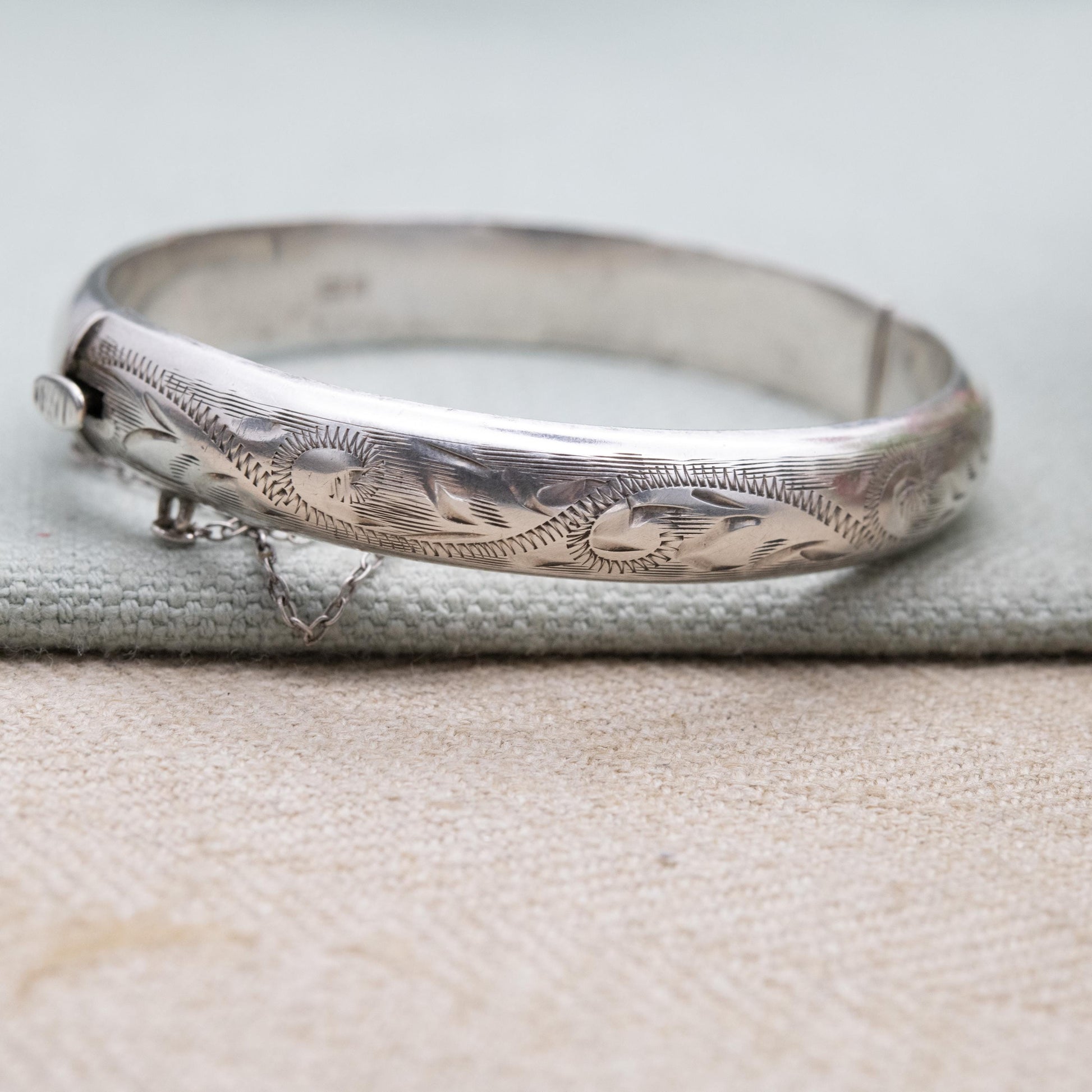 Vintage Sterling Silver Floral Engraved Bangle Bracelet 1972 - Textured Victorian Aesthetic Scrolling Style with Safety Chain