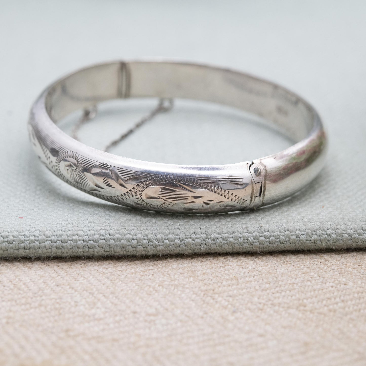 Vintage Sterling Silver Floral Engraved Bangle Bracelet 1972 - Textured Victorian Aesthetic Scrolling Style with Safety Chain