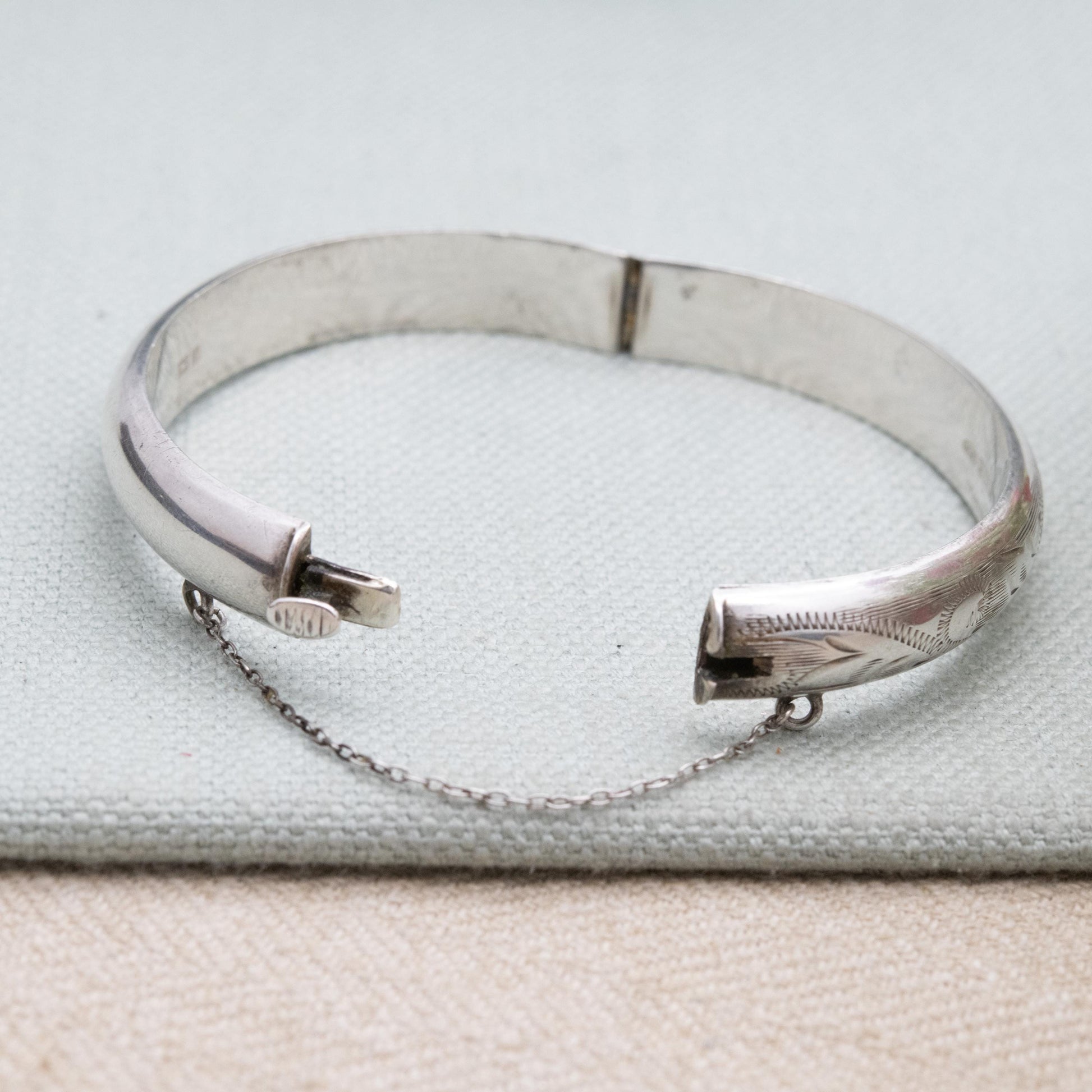 Vintage Sterling Silver Floral Engraved Bangle Bracelet 1972 - Textured Victorian Aesthetic Scrolling Style with Safety Chain